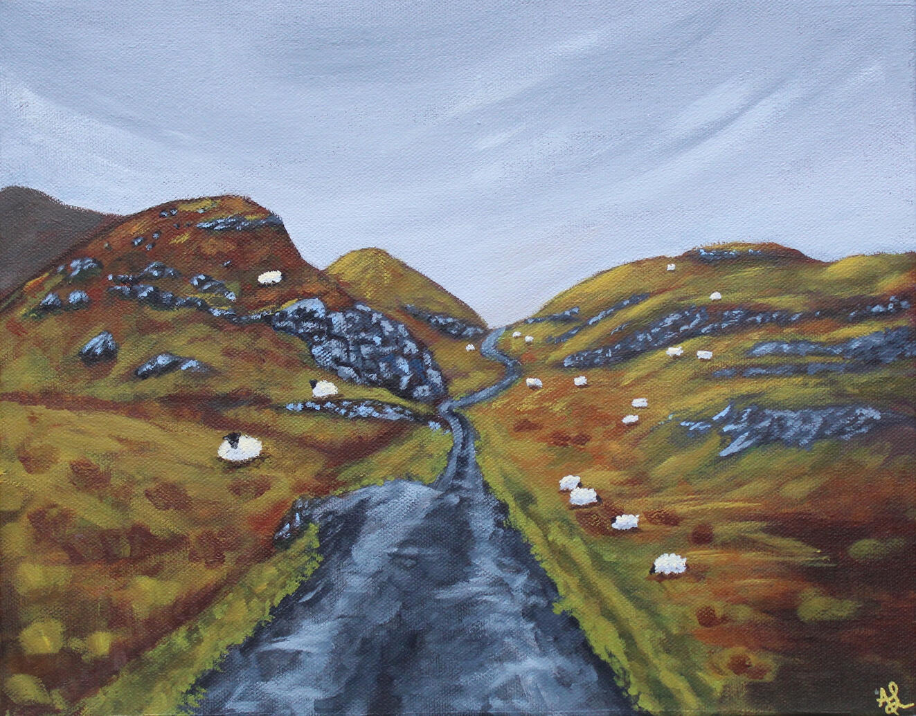 Sheep line a rural road through mountains in Ireland